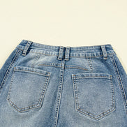 Close-up of a pair of blue jeans on a beige background