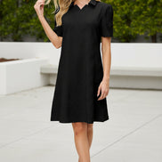 Woman wearing a black dress with a collar on a beige background