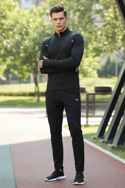 Person wearing a black athletic outfit with a blurred background