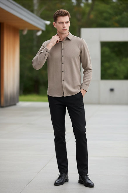 Man wearing a beige button-up shirt against a white background