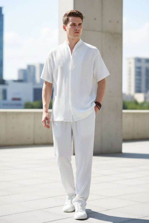 Person wearing a white outfit with a plain background