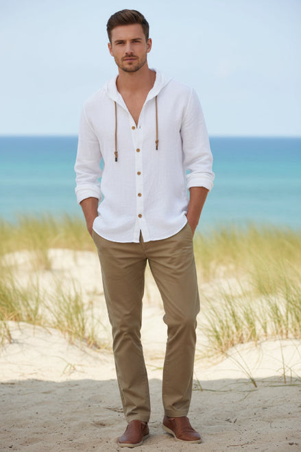 Man wearing a white button-up shirt with a beach background
