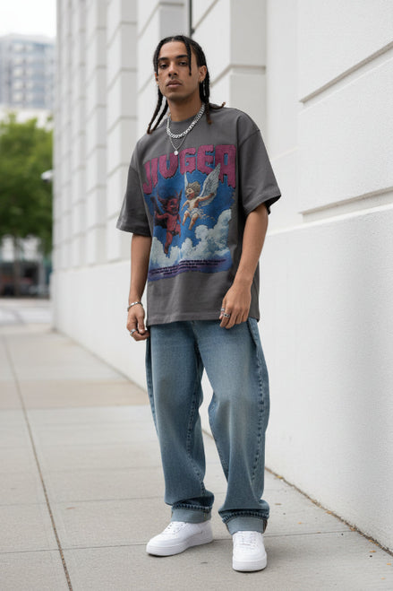 Person wearing a graphic t-shirt with colorful design and text.