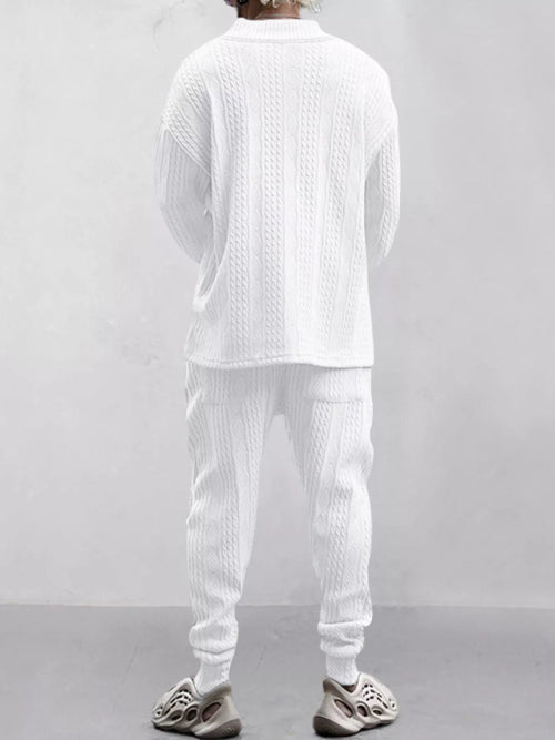 A person shown from the back wearing a matching white textured knit lounge set consisting of a long-sleeve top and jogger pants, 