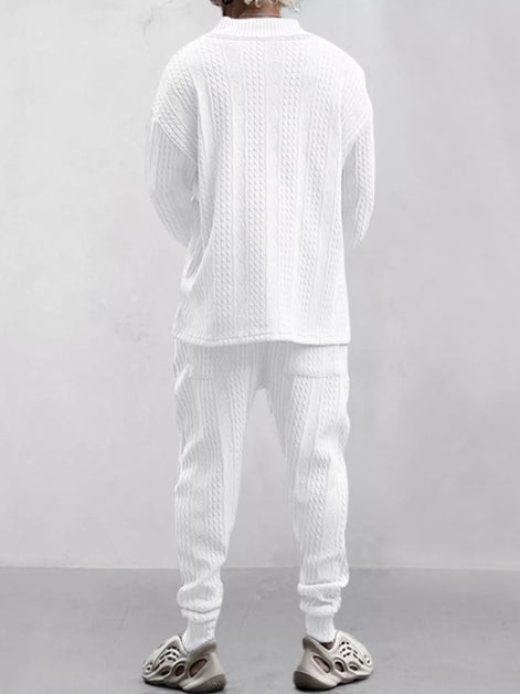 A person shown from the back wearing a matching white textured knit lounge set consisting of a long-sleeve top and jogger pants, 