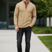 Beige shirt with brown leather accents on a white background