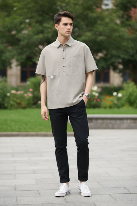 Beige short-sleeve shirt worn by a person on a light gray background