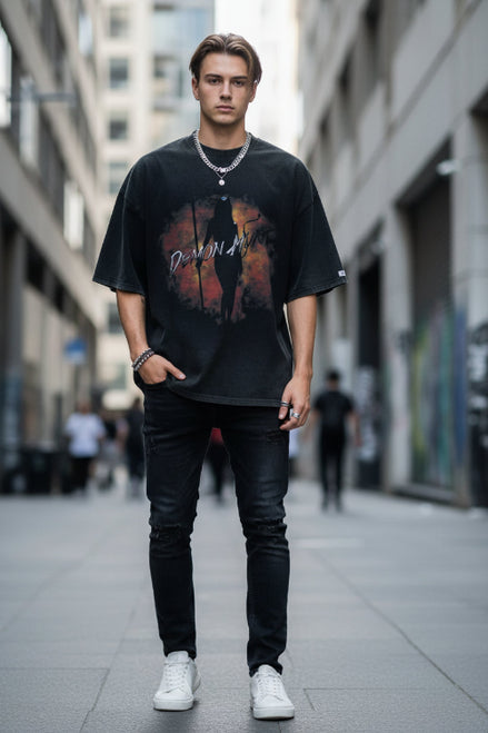 Person wearing a black t-shirt with a graphic design and text.