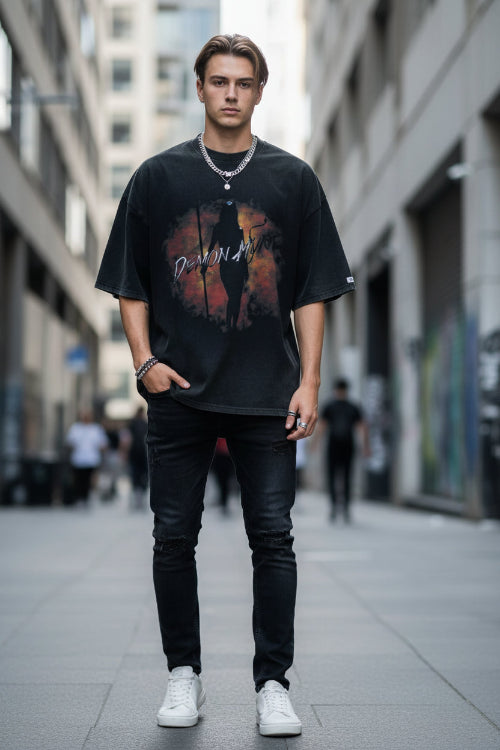 Person wearing a black t-shirt with a graphic design and text.