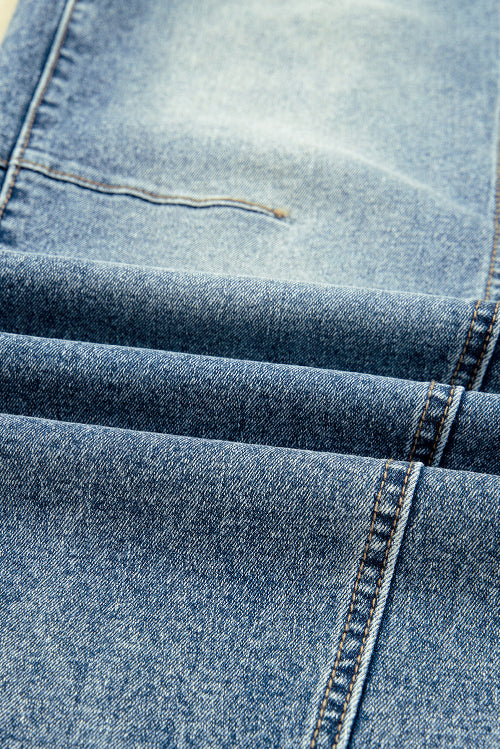 Close-up of blue denim fabric with stitching details