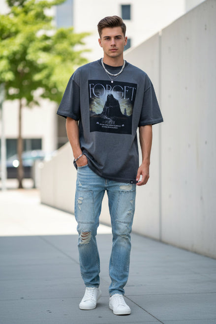 Person wearing a gray t-shirt with a graphic design and text.