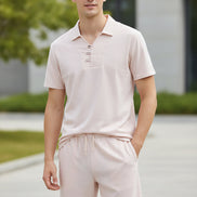 Light pink pajama set on hangers against a white background
