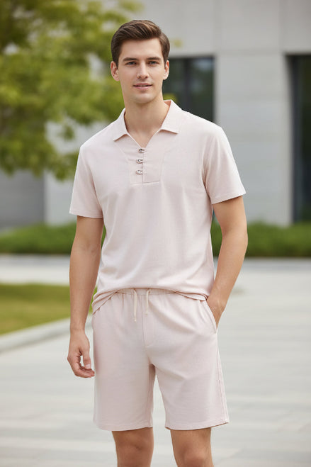 Light pink pajama set on hangers against a white background