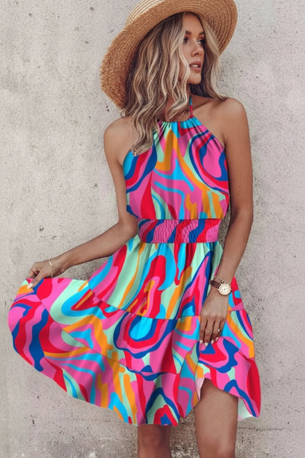 Woman wearing a colorful dress with a concrete wall background
