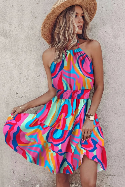 Woman wearing a colorful dress with a concrete wall background