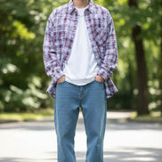 Person wearing a plaid shirt with red and blue patterns on a white background