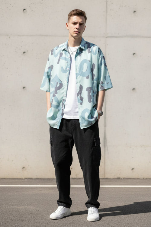 Person wearing a light blue camouflage-patterned shirt with a white background