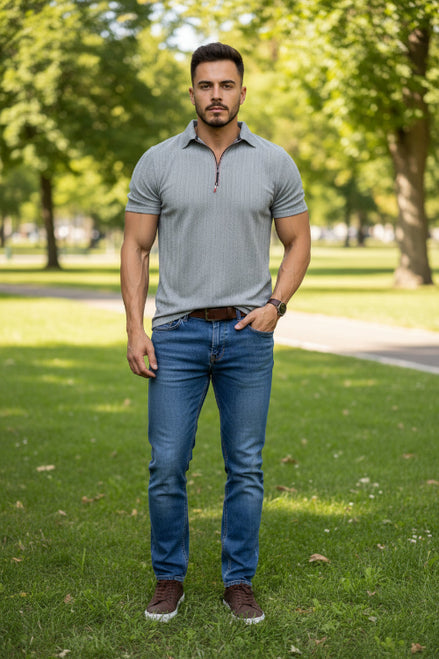 Man wearing a gray short-sleeve polo shirt with a zipper on a white background