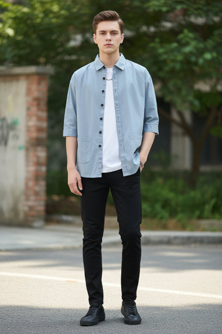 Light blue button-up shirt worn by a person on a white background