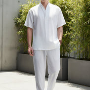 Person wearing a white outfit with a plain background
