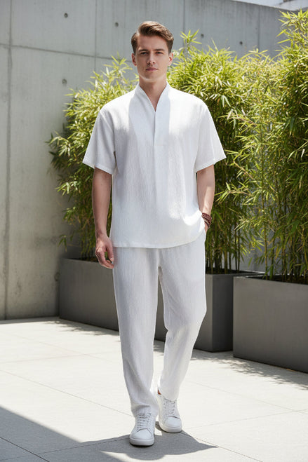 Person wearing a white outfit with a plain background