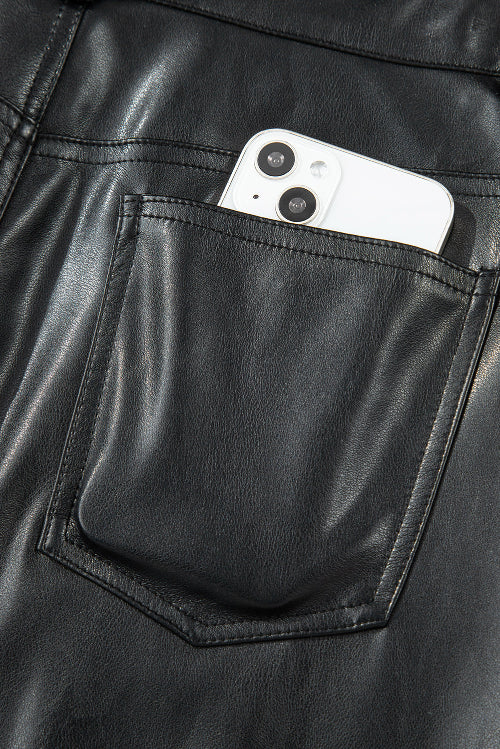 Phone in a pocket of black leather jacket
