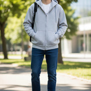 Gray zip-up hoodie worn by a person on a light gray background