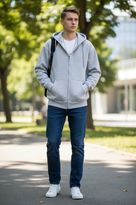 Gray zip-up hoodie worn by a person on a light gray background