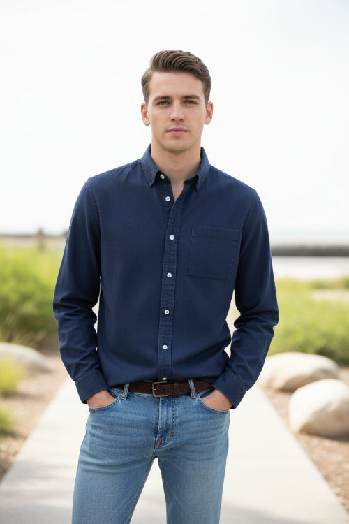 Navy blue button-up shirt worn by a person on a light gray background
