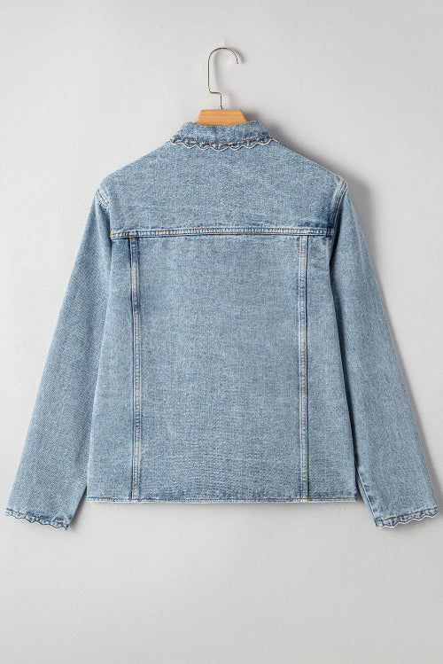 Light blue denim jacket on a hanger against a white background