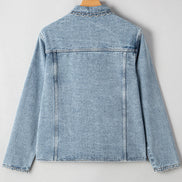 Light blue denim jacket on a hanger against a white background
