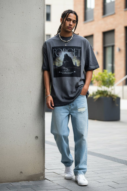 Person wearing a gray t-shirt with a graphic design and text.
