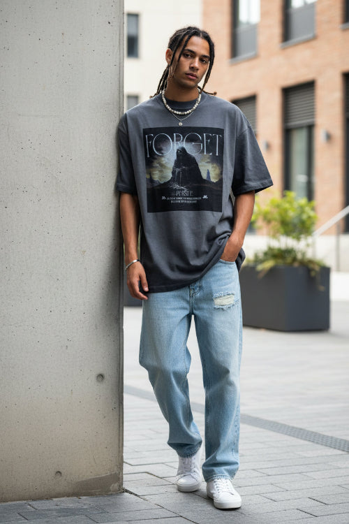Person wearing a gray t-shirt with a graphic design and text.