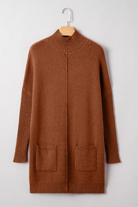Brown sweater dress on a hanger against a light gray background