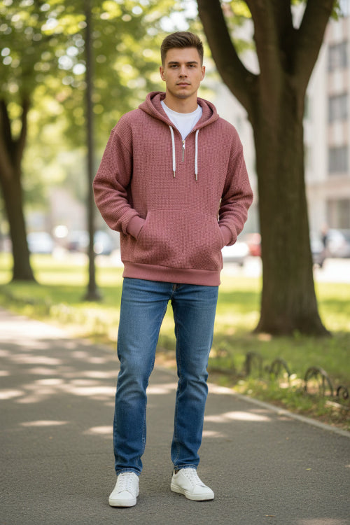 Maroon pullover with a zipper worn by a person on a white background