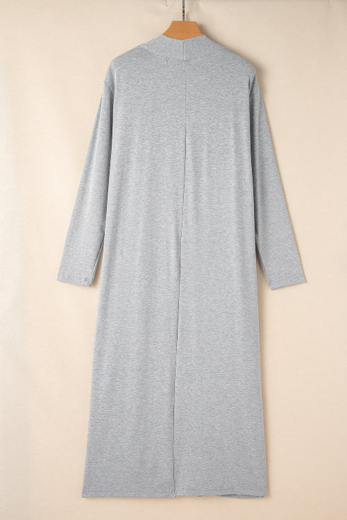 Gray long-sleeve dress on a beige hanger against a beige background