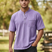 Man wearing a purple short-sleeve shirt with a pocket on a white background
