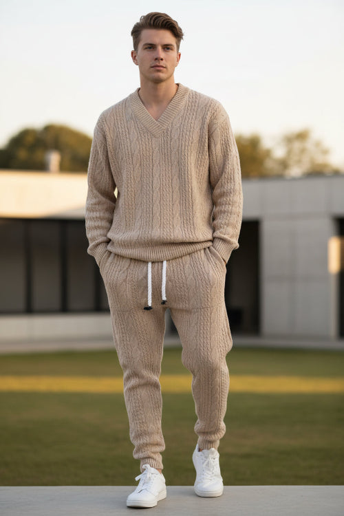 A person modeling a matching beige cable-knit sweater and jogger pants set with white drawstrings, 