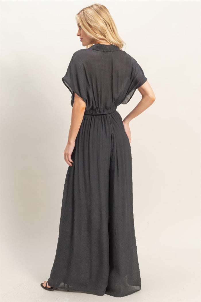 Woman wearing a black dress with a plain background
