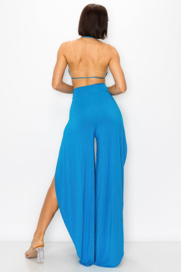 Woman wearing a blue outfit with wide-leg pants on a white background