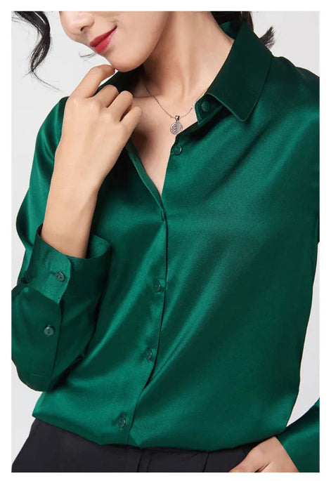 Close-up of a green silk shirt's collar and button front.