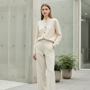 Beige cardigan with brown buttons on a white background