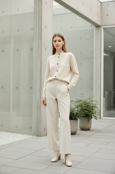 Beige cardigan with brown buttons on a white background