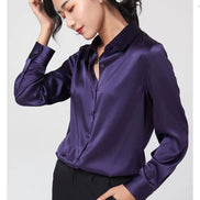 Close-up of a purple silk shirt's collar and button front.