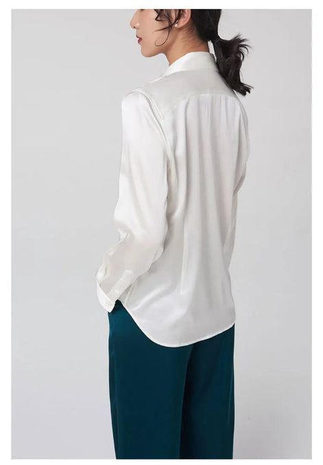 White silk shirt worn by a model, shown from the back.
