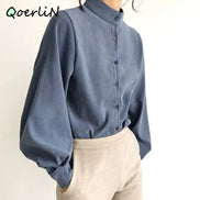 Blue long-sleeve shirt worn by a person on a plain background