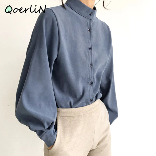Blue long-sleeve shirt worn by a person on a plain background