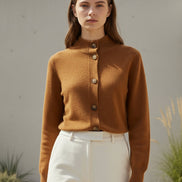 A warm camel-brown knit cardigan sweater with a mock neck and button-front closure, shown on a white background 