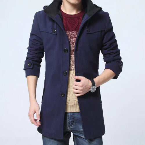 Navy blue coat worn by a person on a light gray background