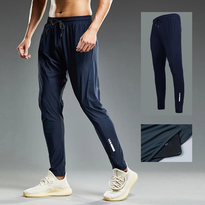 Person wearing navy jogger pants with a close-up inset on a gray background